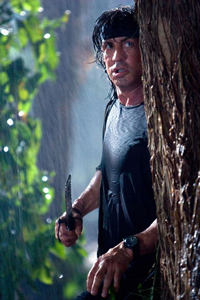 sylvester stallone behind a tree