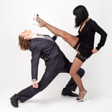 woman-kicks-man-in-suit